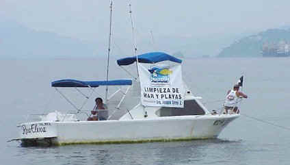 Sam Short raises the Mexican flag on his fishing boat, "Rosa Elena."