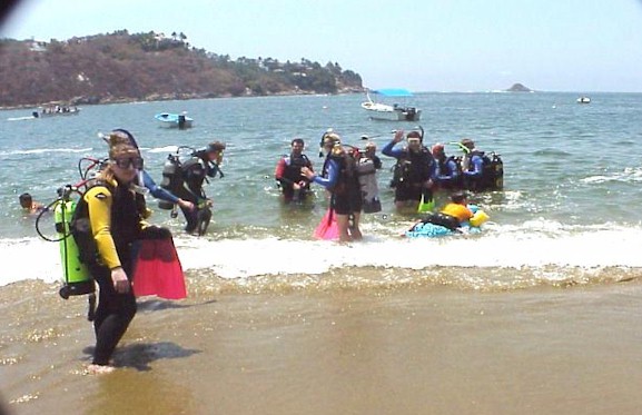 A busy beach: divers, swimmers, boaters